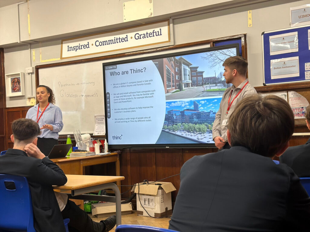 Employees from Thinc present to a class of young people at St Bede's College, Manchester