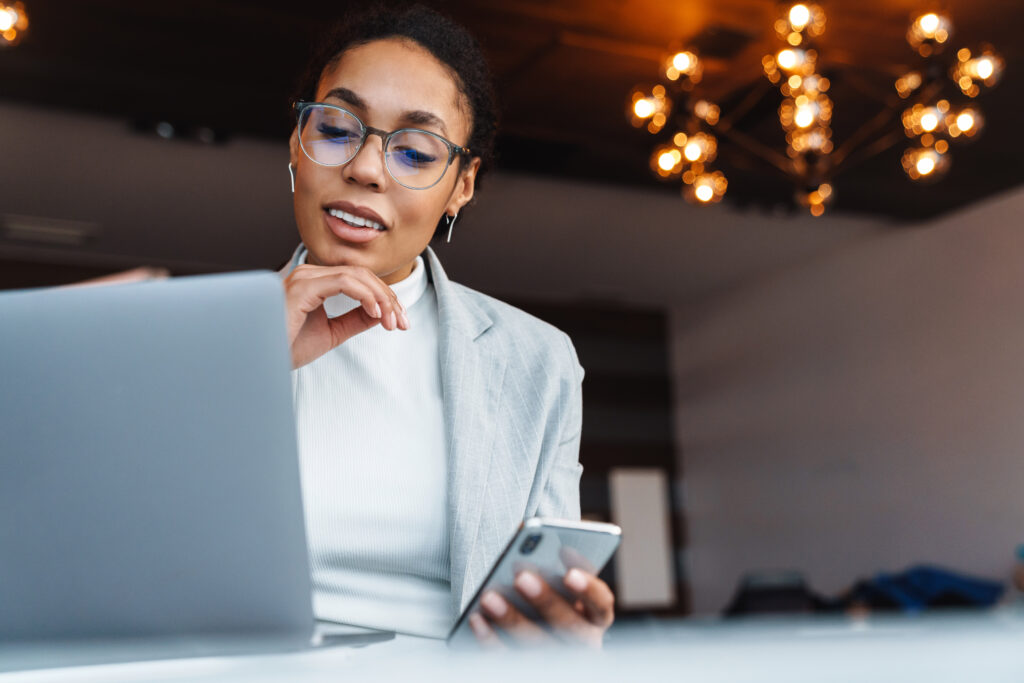 Image of african american businesswoman working on laptop in off