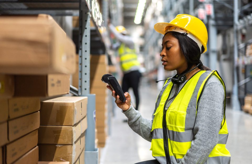 Lady in warehouse scanning stock