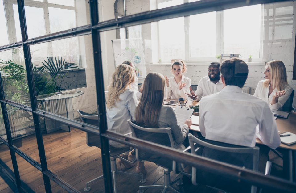 Photo of group smart people marketers investors, sit table analyze way-out crisis strategy tell talk say speak solution wear formal outfit in boardroom workplace workstation